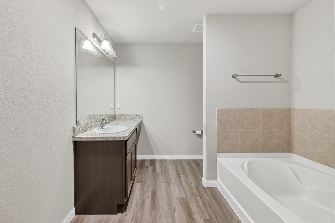 2516 Boss Street La Marque, TX 77568 - Photo 20 of 46 a bathroom with a tub sink and mirror