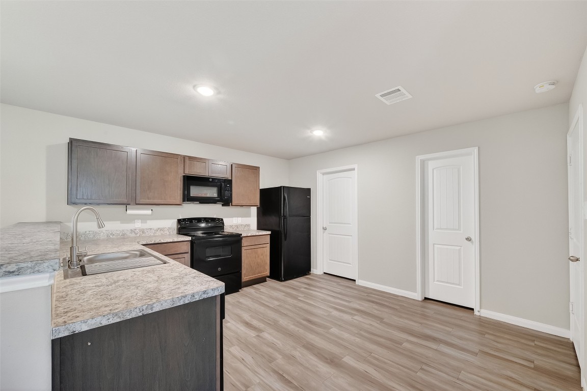 2516 Boss Street La Marque, TX 77568 - Photo 22 of 46 a kitchen with stainless steel appliances granite countertop a sink stove and refrigerator