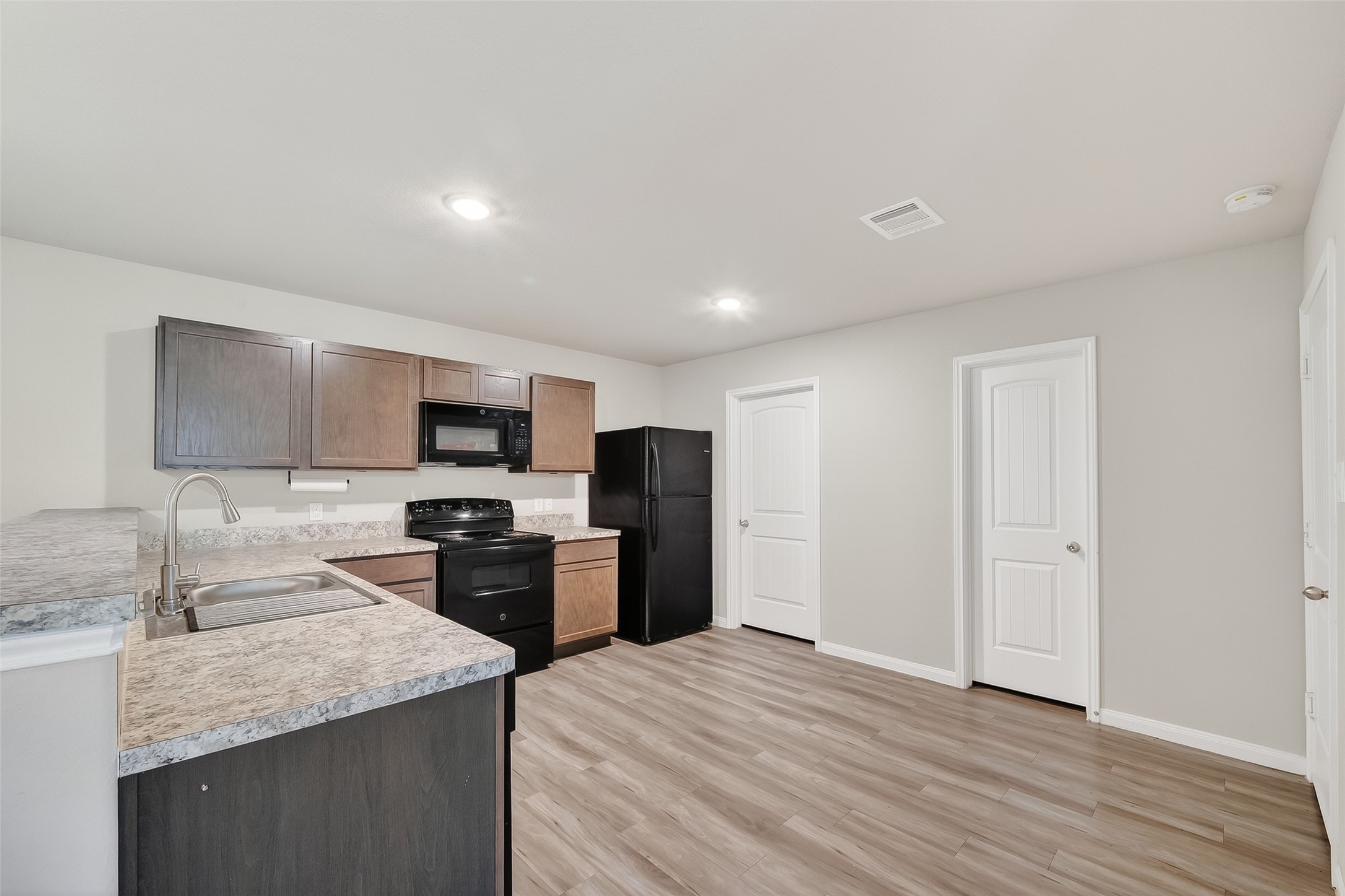 2516 Boss Street La Marque, TX 77568 - Photo 22 of 46 a kitchen with stainless steel appliances granite countertop a sink stove and refrigerator