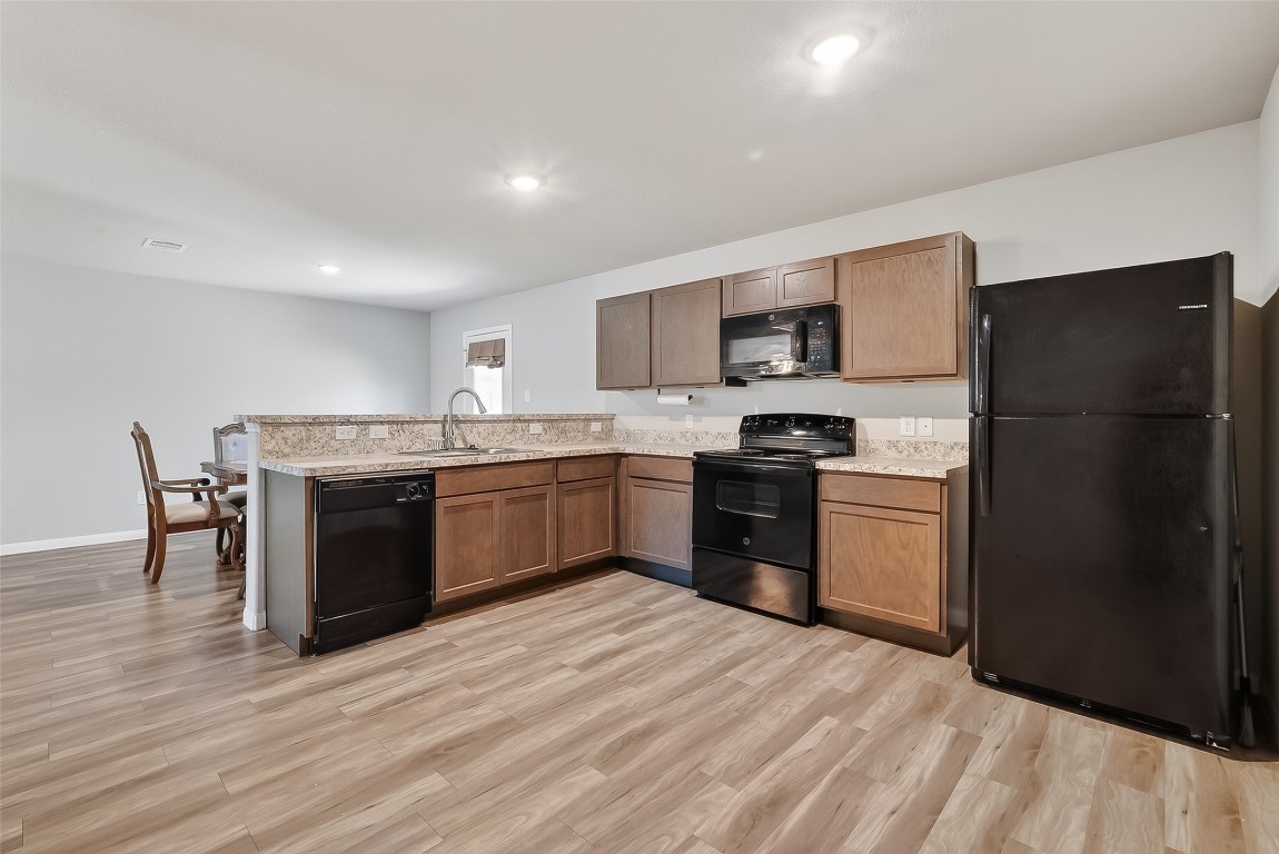 2516 Boss Street La Marque, TX 77568 - Photo 27 of 46 a kitchen with a refrigerator and a stove top oven