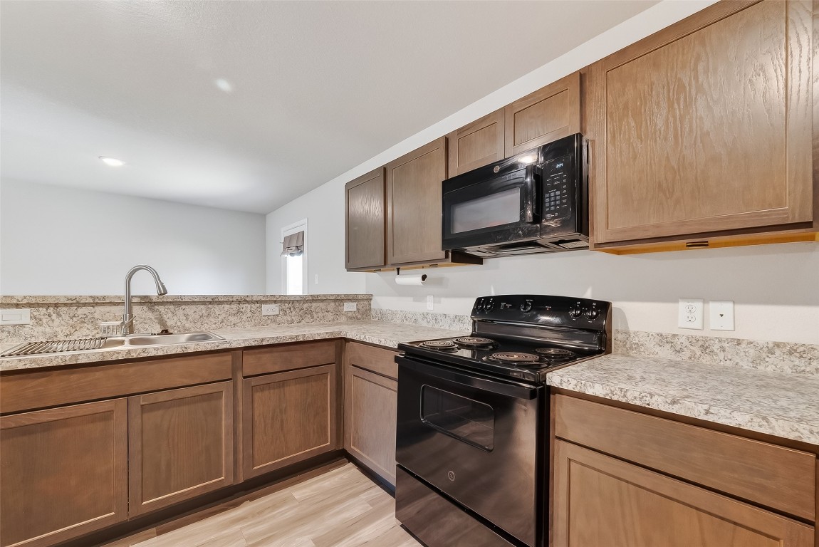 2516 Boss Street La Marque, TX 77568 - Photo 29 of 46 a kitchen with stainless steel appliances granite countertop a sink stove and microwave