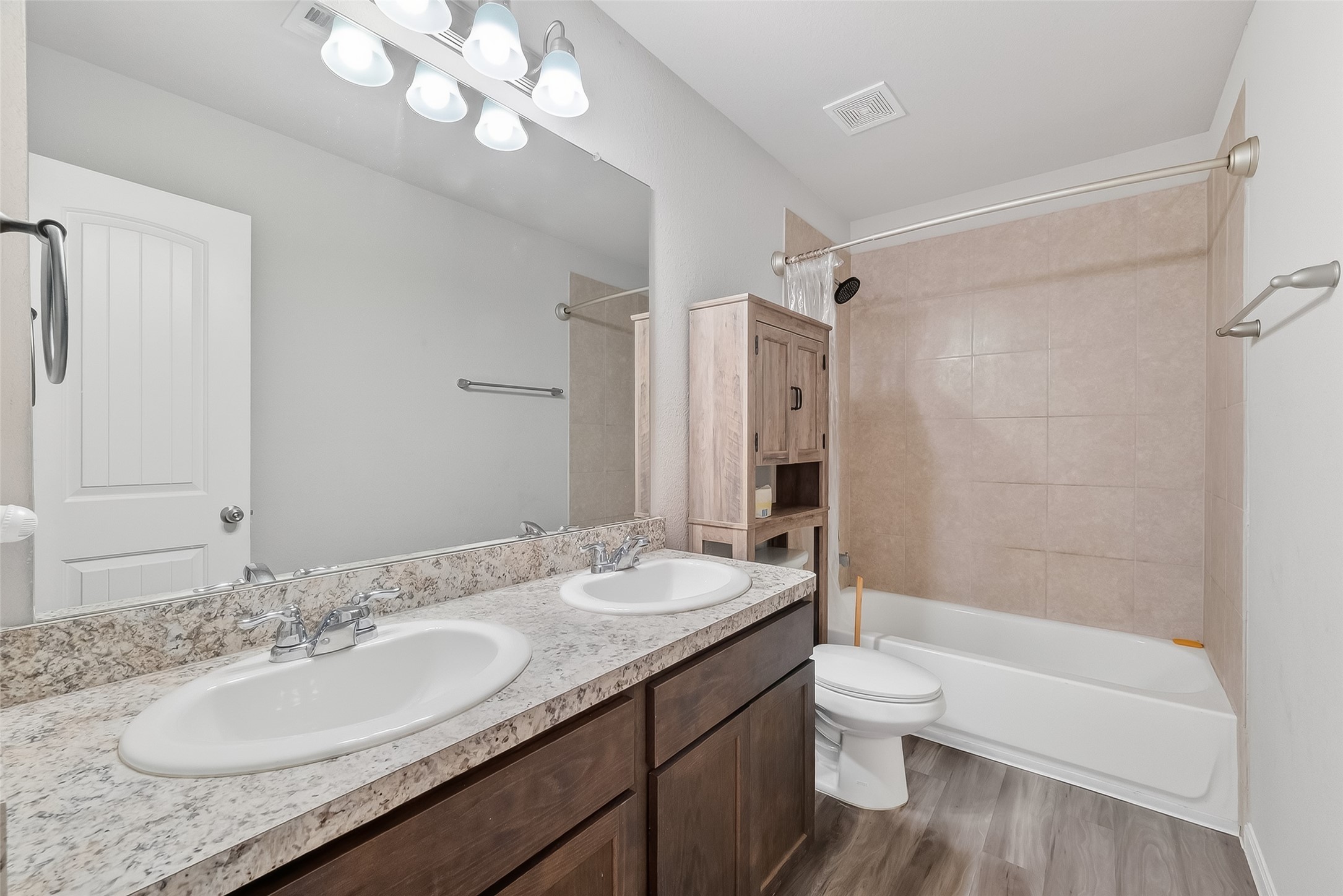 2516 Boss Street La Marque, TX 77568 - Photo 30 of 46 a bathroom with a granite countertop sink a toilet a mirror a bathtub and shower