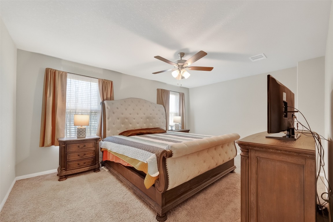 2516 Boss Street La Marque, TX 77568 - Photo 32 of 46 a bedroom with a bed and a chandelier