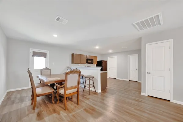 a view of a dining room with furniture and wooden floor