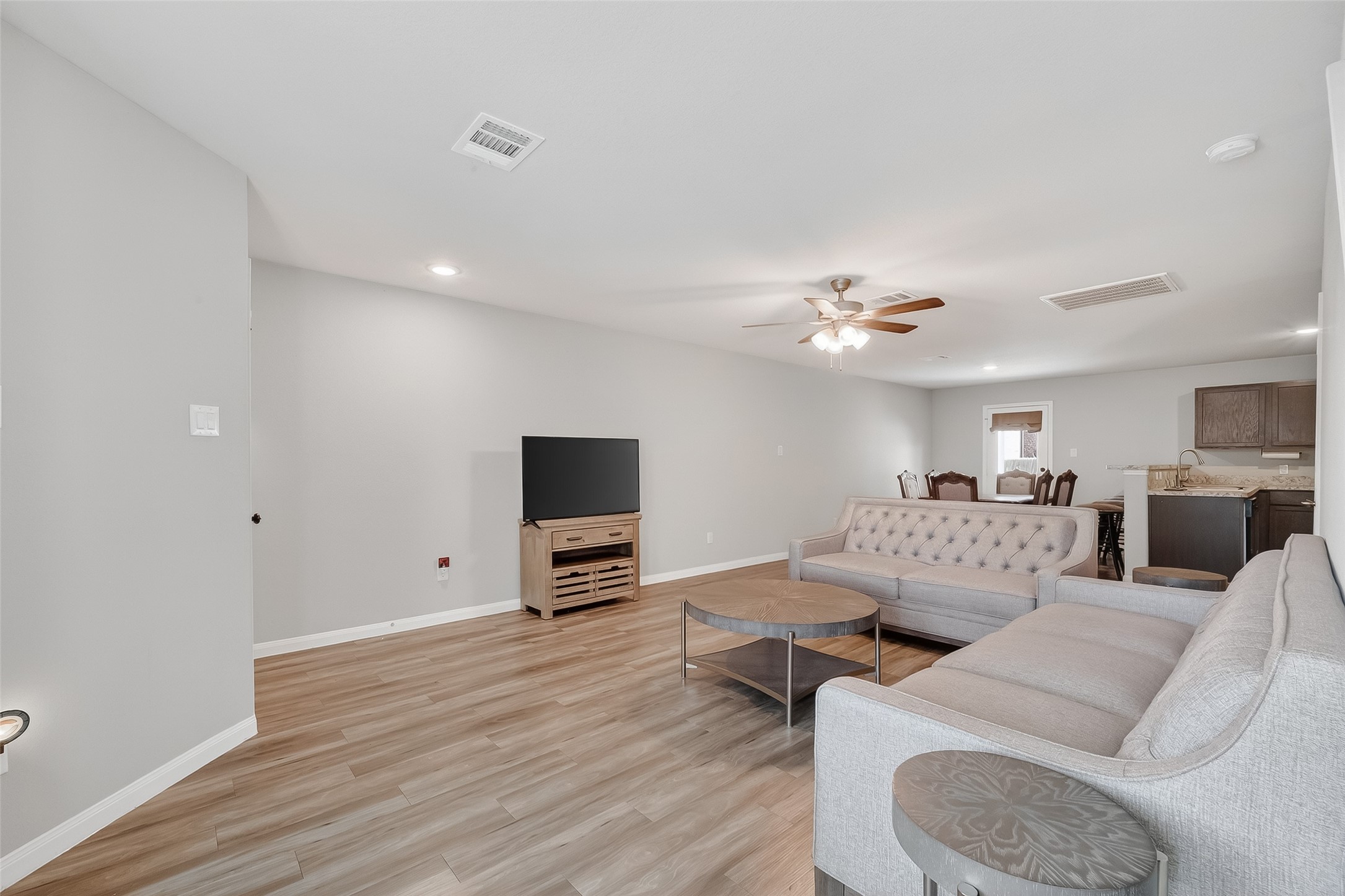 2516 Boss Street La Marque, TX 77568 - Photo 8 of 46 a living room with furniture a flat screen tv and a ceiling fan