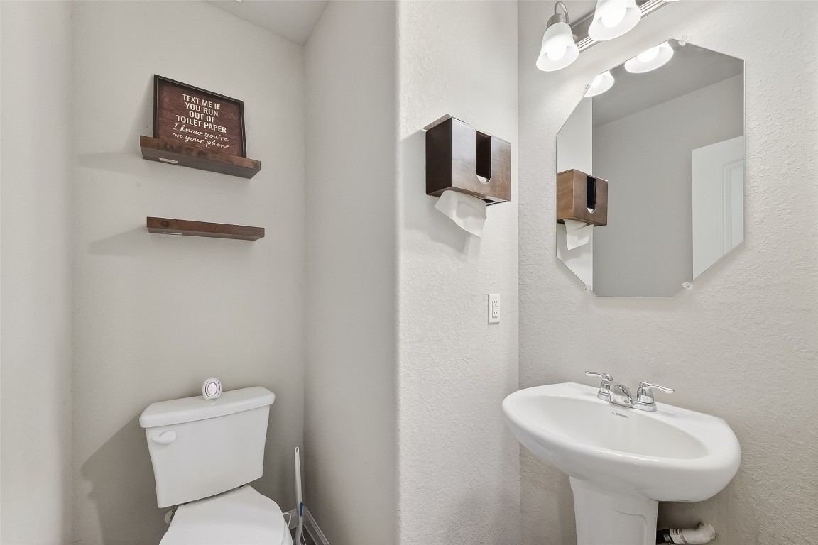 2516 Boss Street La Marque, TX 77568 - Photo 10 of 46 a bathroom with a toilet sink and mirror