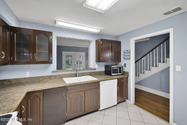 a kitchen with a sink stove and cabinets