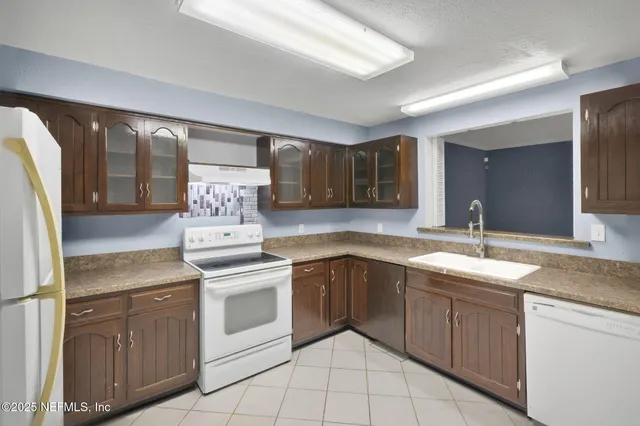a kitchen with a sink stove and refrigerator