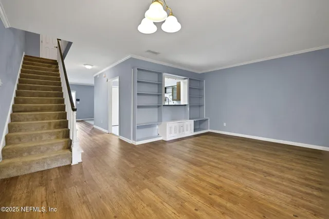 a view of an empty room with stairs