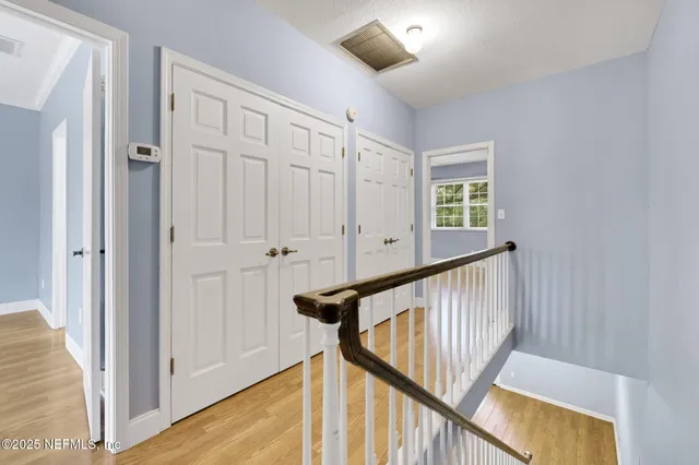 a view of a livingroom with wooden floor and staircase