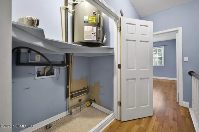 a spacious bedroom with a large bed and a chandelier