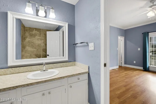 a bathroom with a granite countertop sink a toilet and a mirror