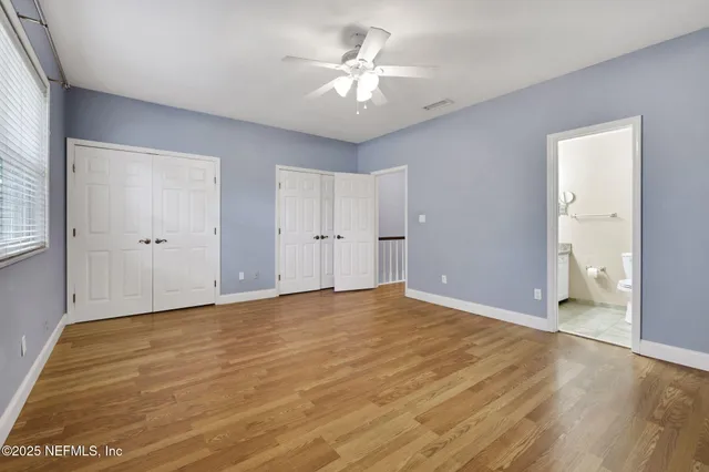 a bathroom with a granite countertop sink a toilet and a mirror