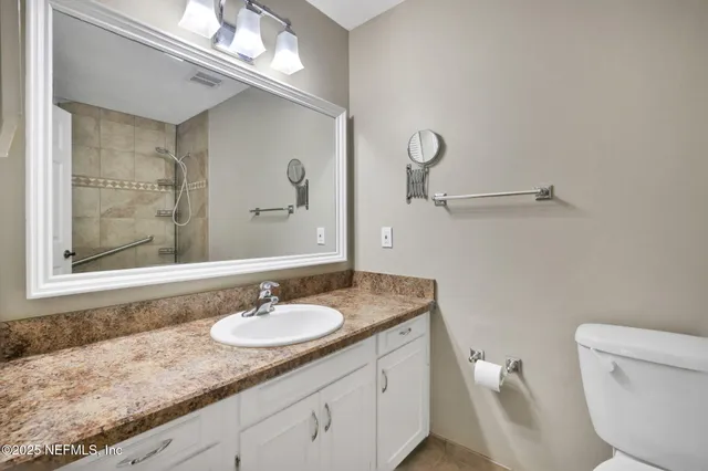 a white bath tub sitting next to a toilet
