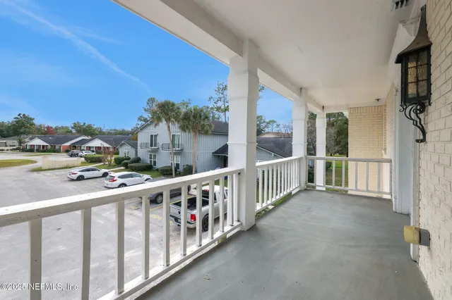 a view of an entryway with wooden floor and windows