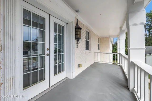 a view of a house with wooden deck and city view