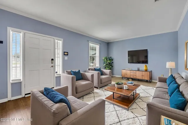 a living room with furniture and a flat screen tv
