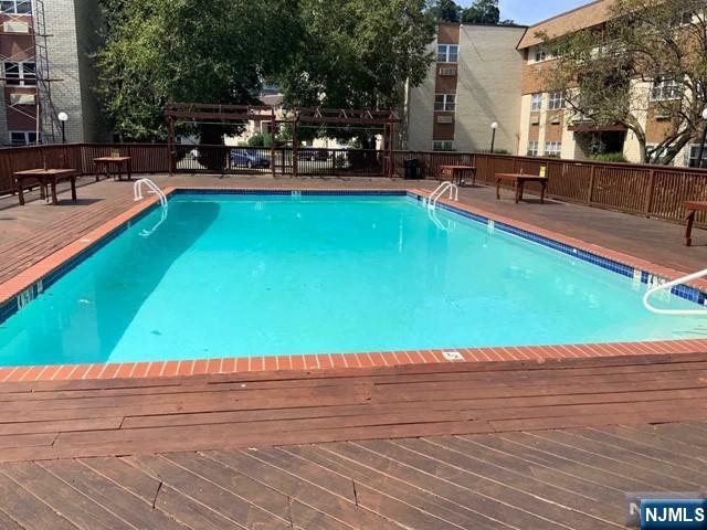1111 River Road, Unit F2 Edgewater, NJ 07020 - Photo 4 of 21 a swimming pool with outdoor seating and yard