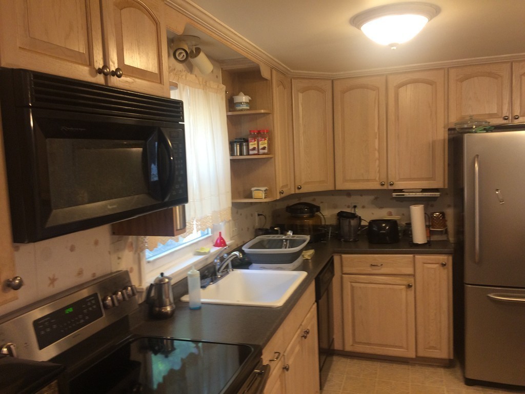 23 Mohawk Road Marblehead, MA 01945 - Photo 8 of 22 a kitchen with a sink stove and refrigerator