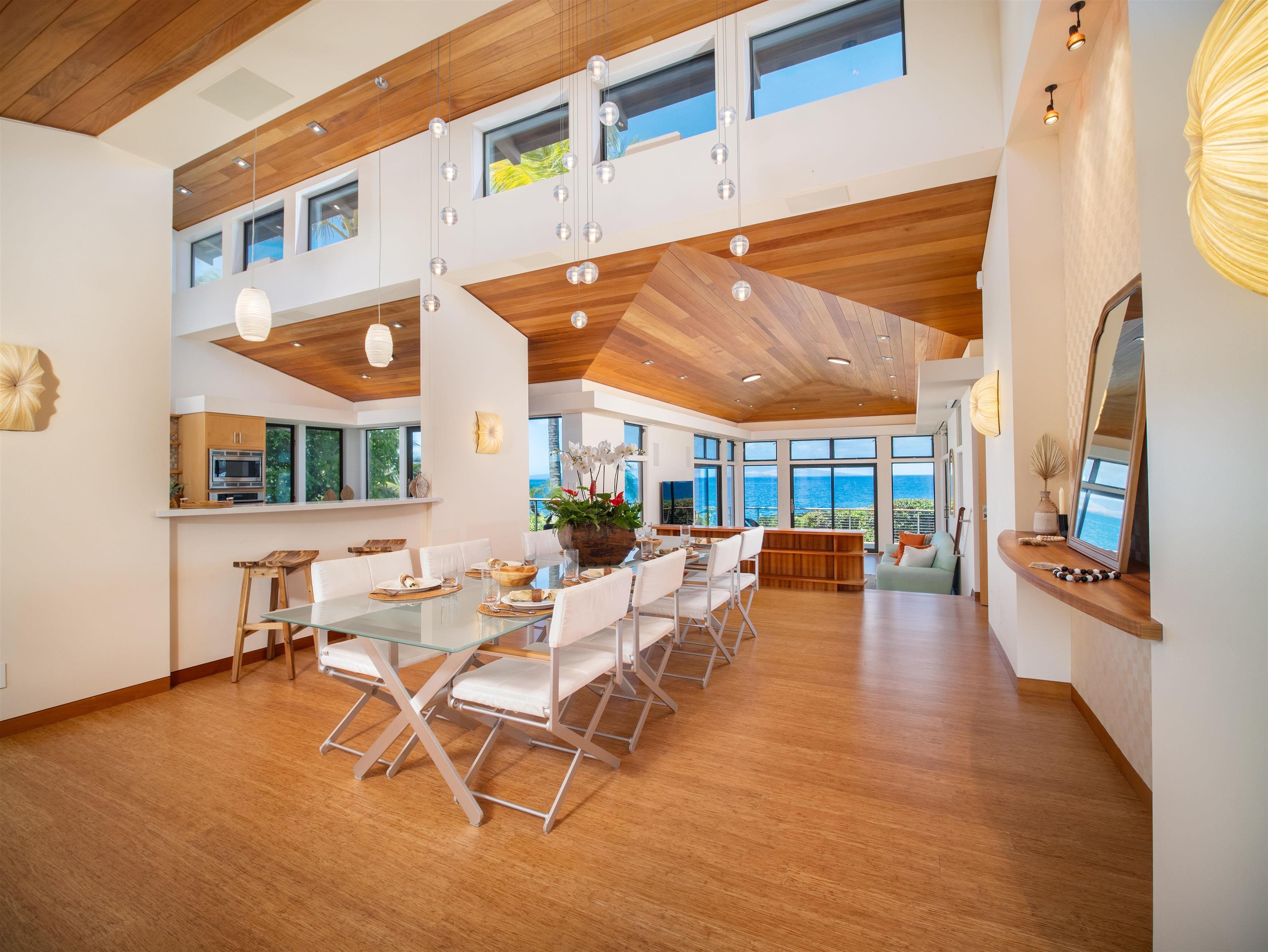 4640-4650 Makena Road Kihei, HI 96753 - Photo 40 of 48 a view of a patio with table and chairs with wooden floor and fence