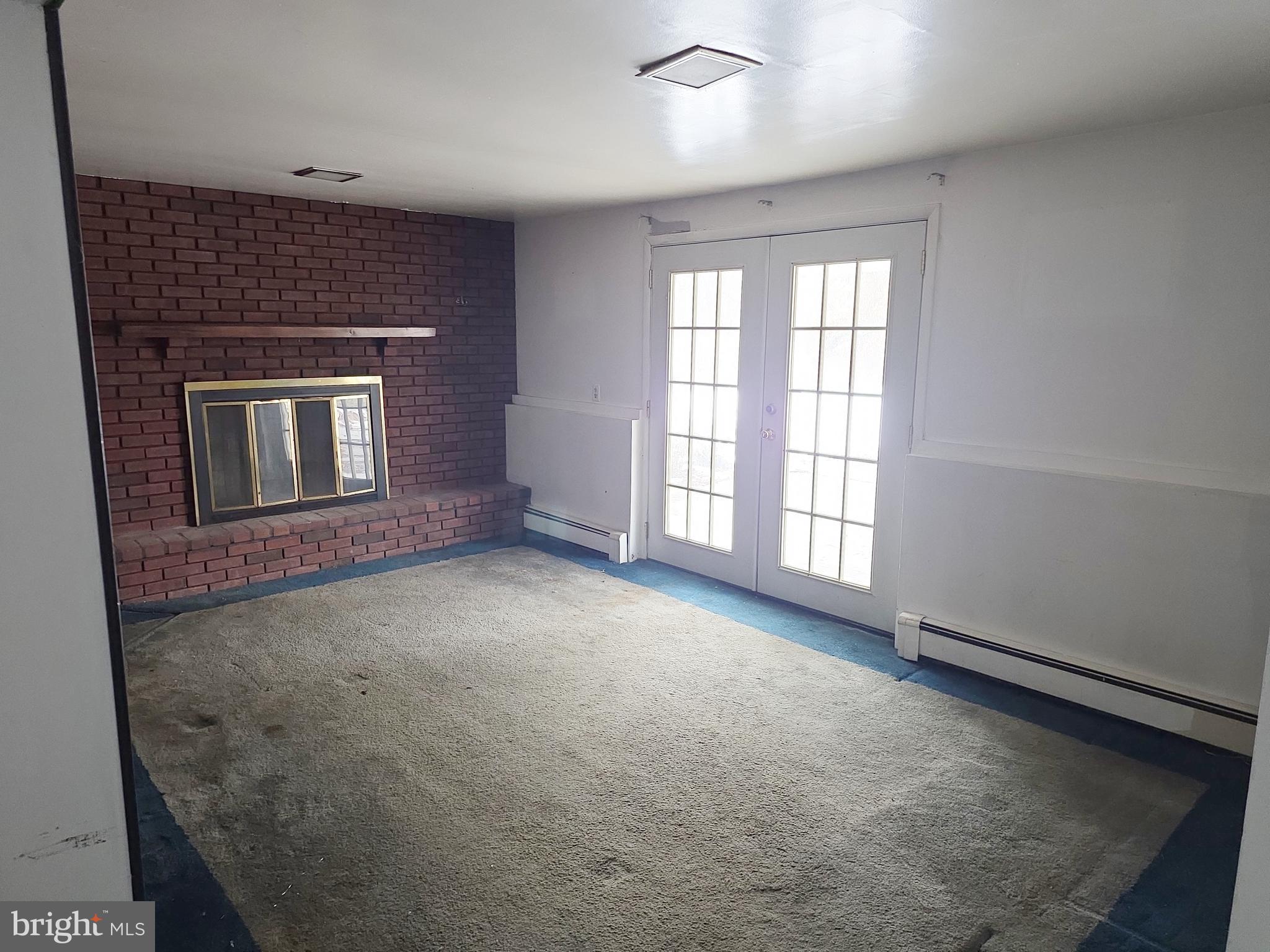 60 Carter Road Princeton, NJ 08540 - Photo 14 of 43 a view of an empty room with a fireplace and a window