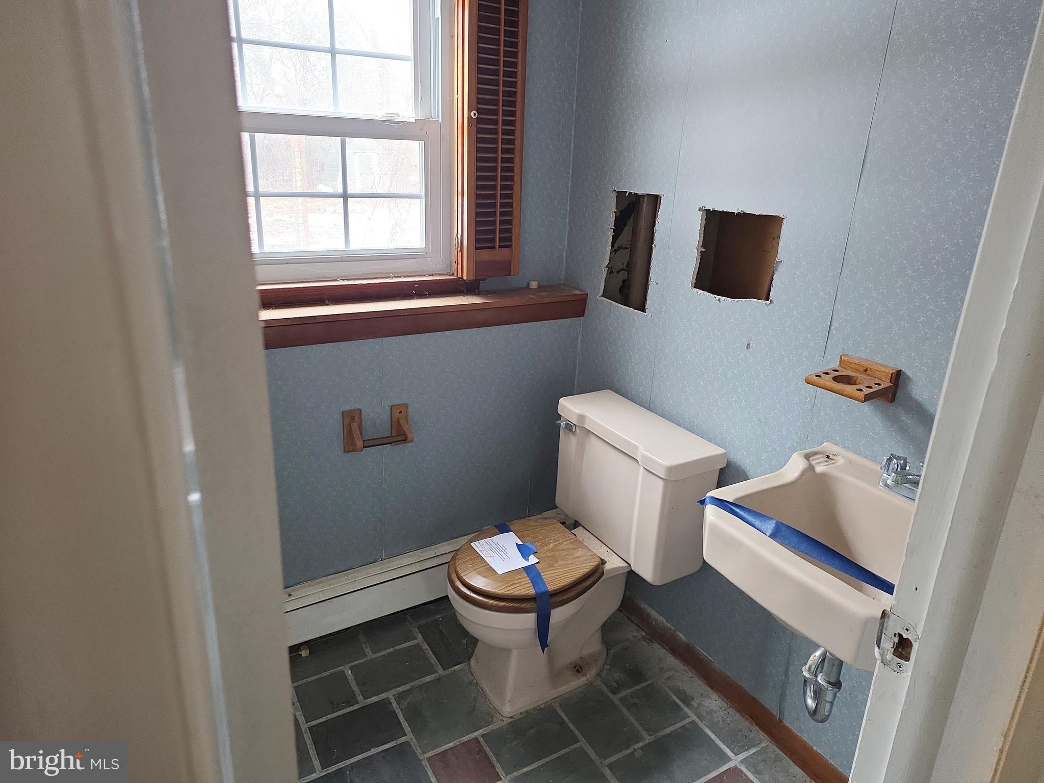 60 Carter Road Princeton, NJ 08540 - Photo 18 of 43 a white toilet sitting next to a bathroom sink and a window