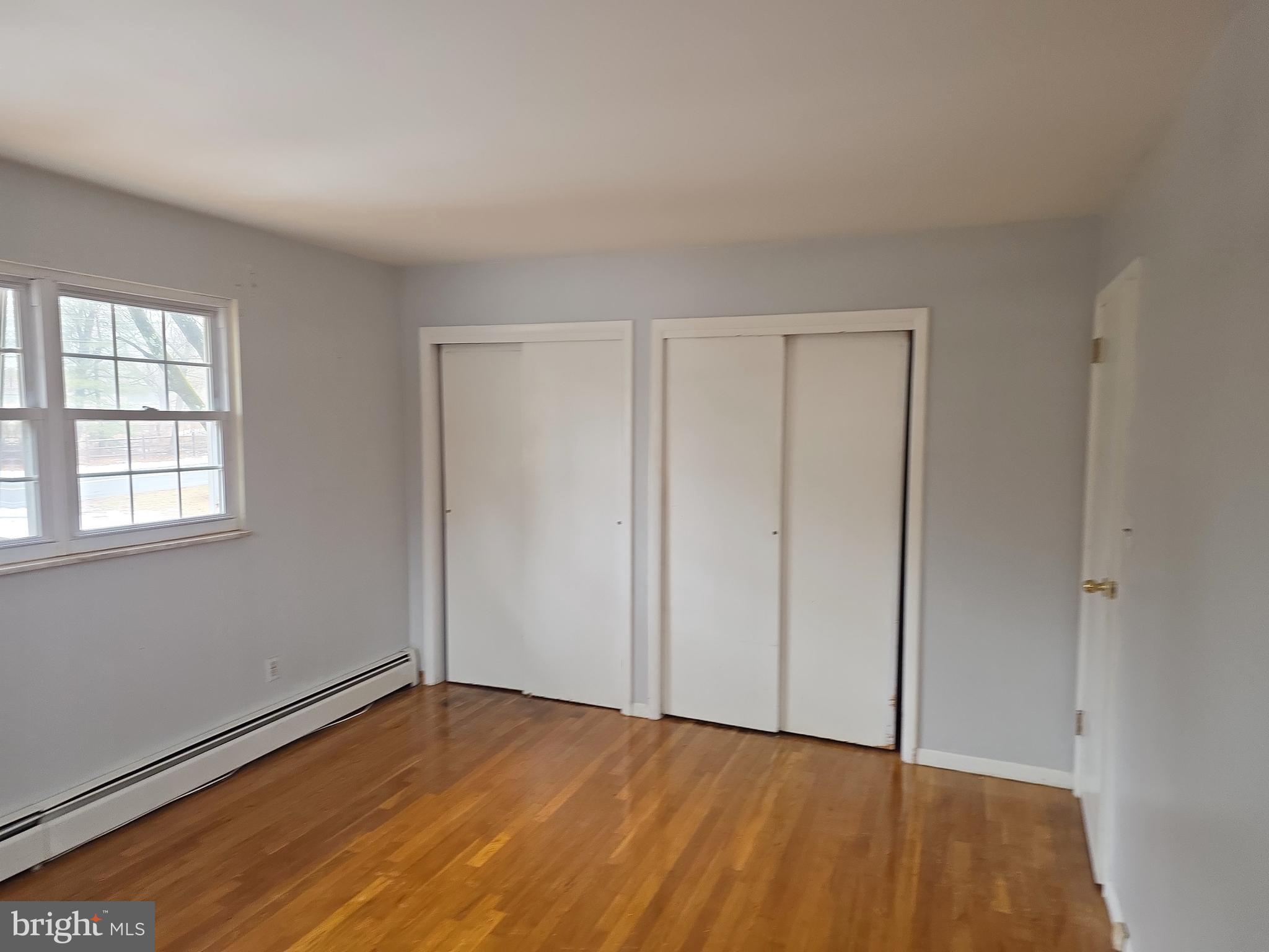 60 Carter Road Princeton, NJ 08540 - Photo 37 of 43 a view of an empty room with wooden floor and a window