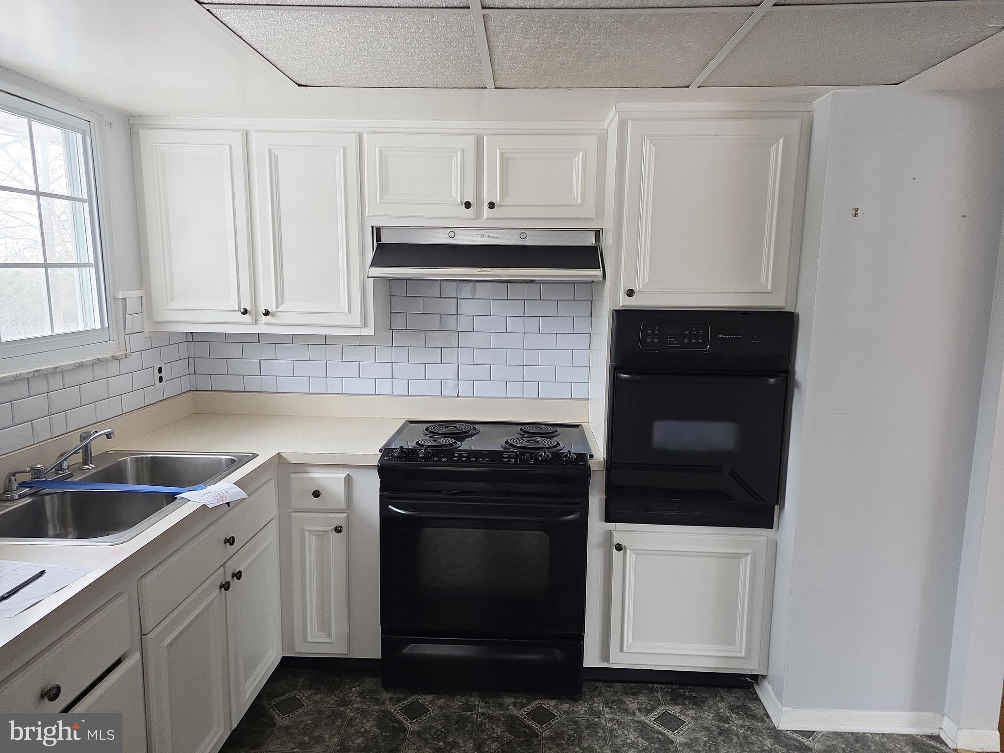 60 Carter Road Princeton, NJ 08540 - Photo 8 of 43 a kitchen with white cabinets and white appliances