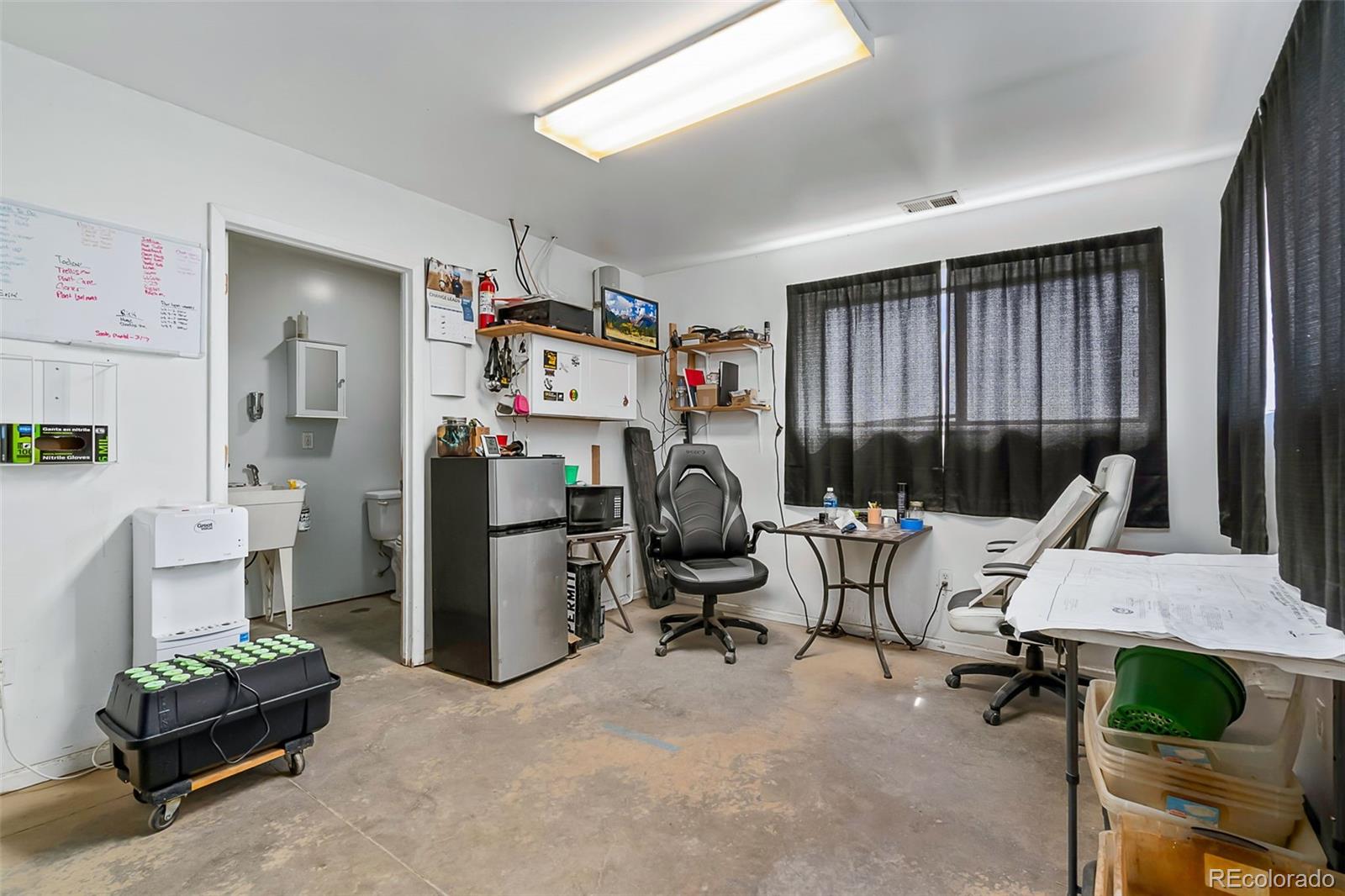 20179 Rawhide Flats Road Wellington, CO 80549 - Photo 7 of 12 a view of a workspace with furniture and a window