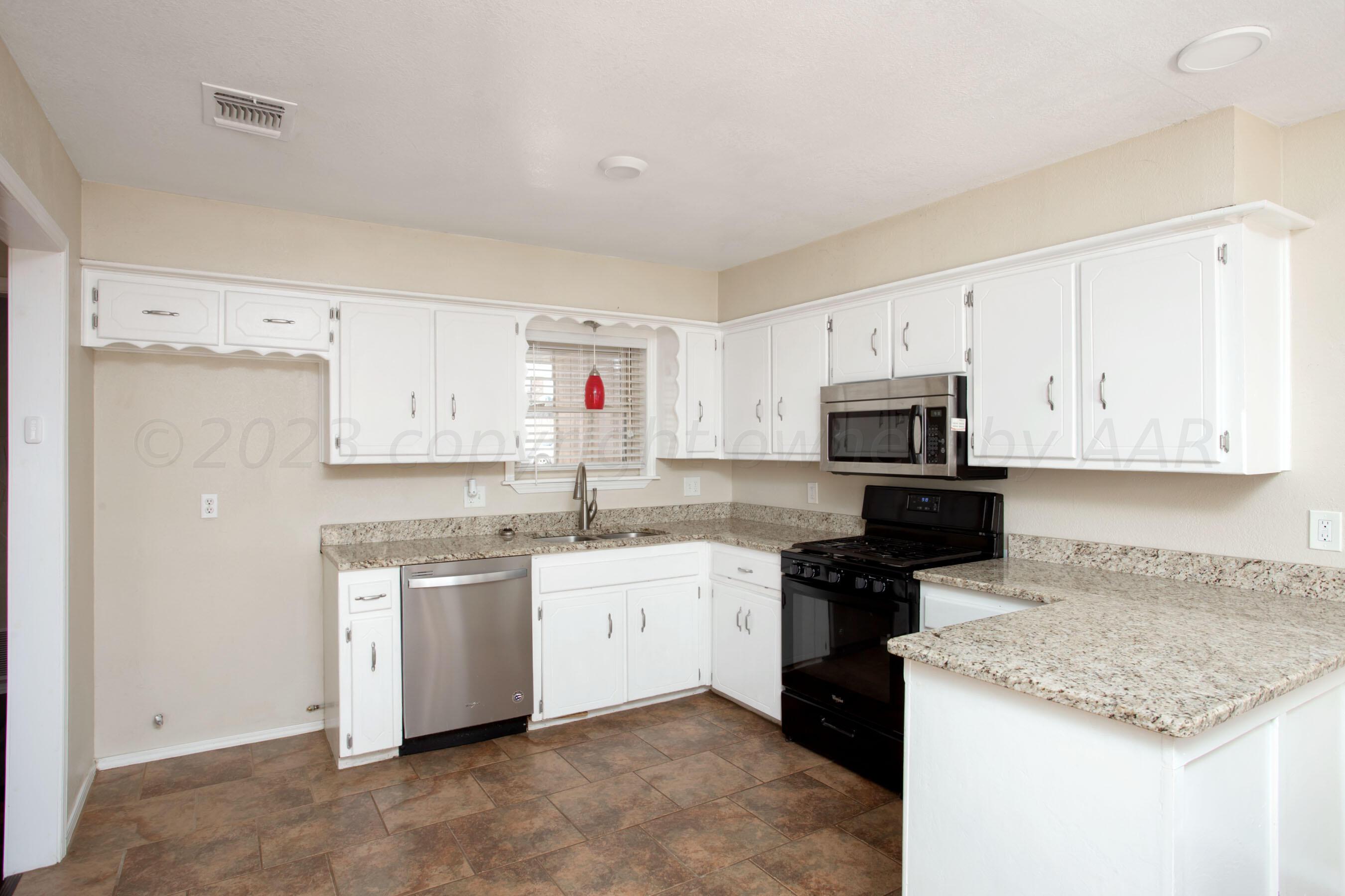 2905 Salem Drive Amarillo, TX 79110 - Photo 13 of 29 a kitchen with a sink stove top oven and cabinets