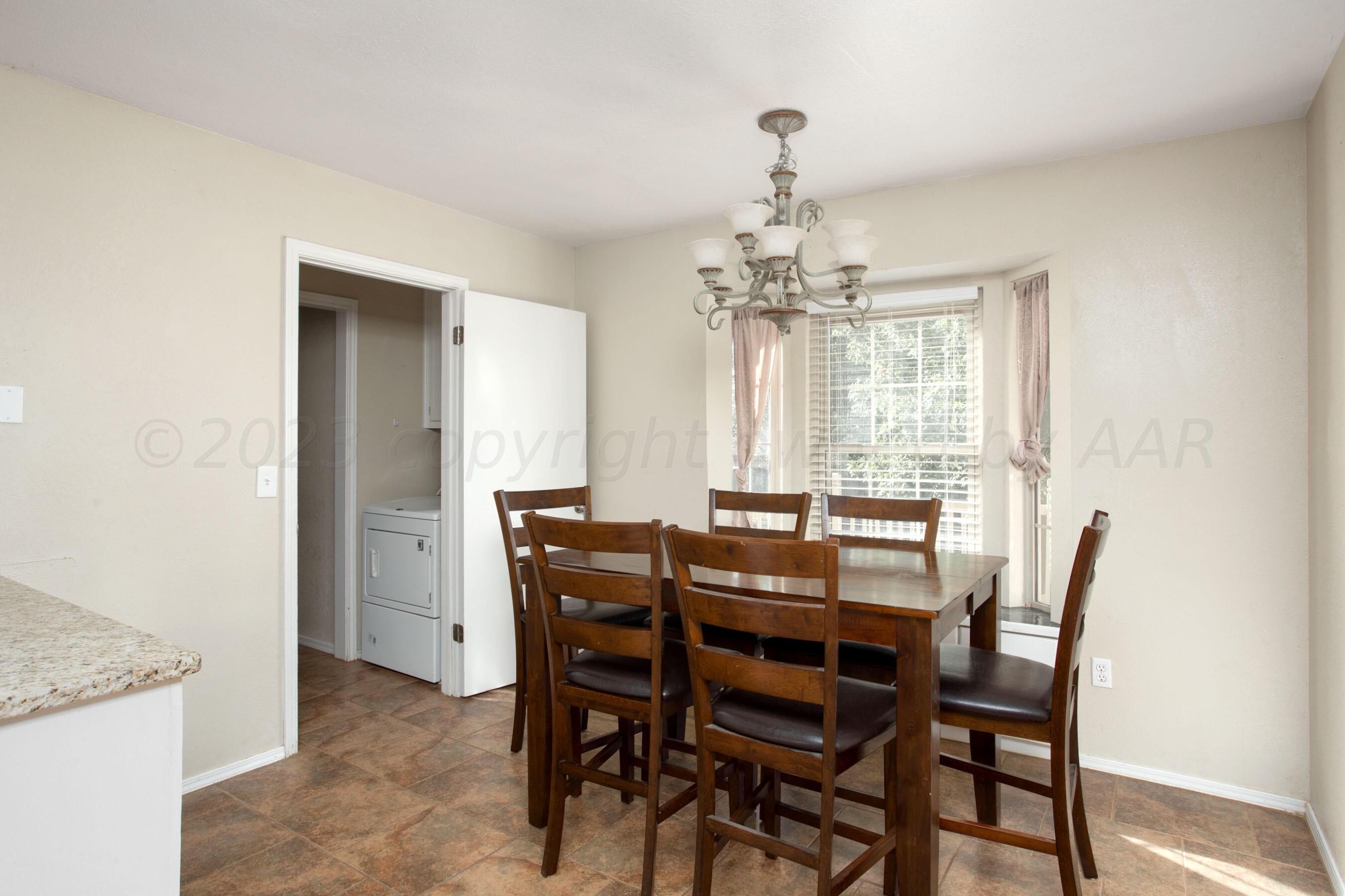 2905 Salem Drive Amarillo, TX 79110 - Photo 14 of 29 a view of a dining room with furniture and chandelier