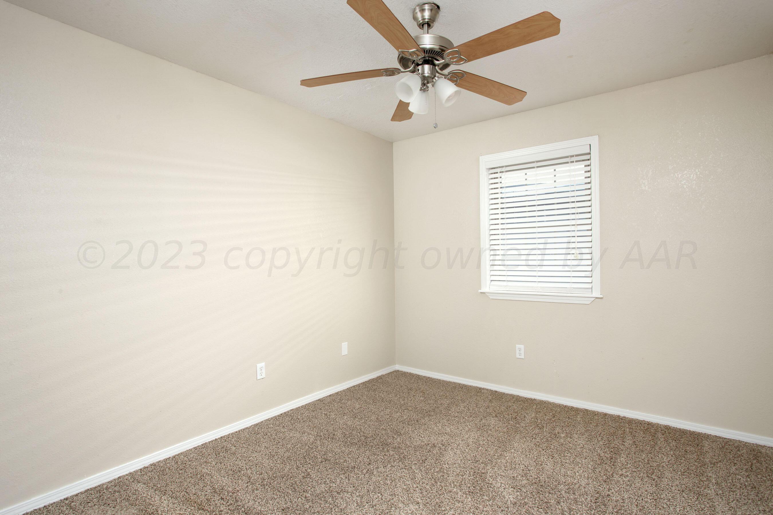 2905 Salem Drive Amarillo, TX 79110 - Photo 15 of 29 an empty room with a window and a fan