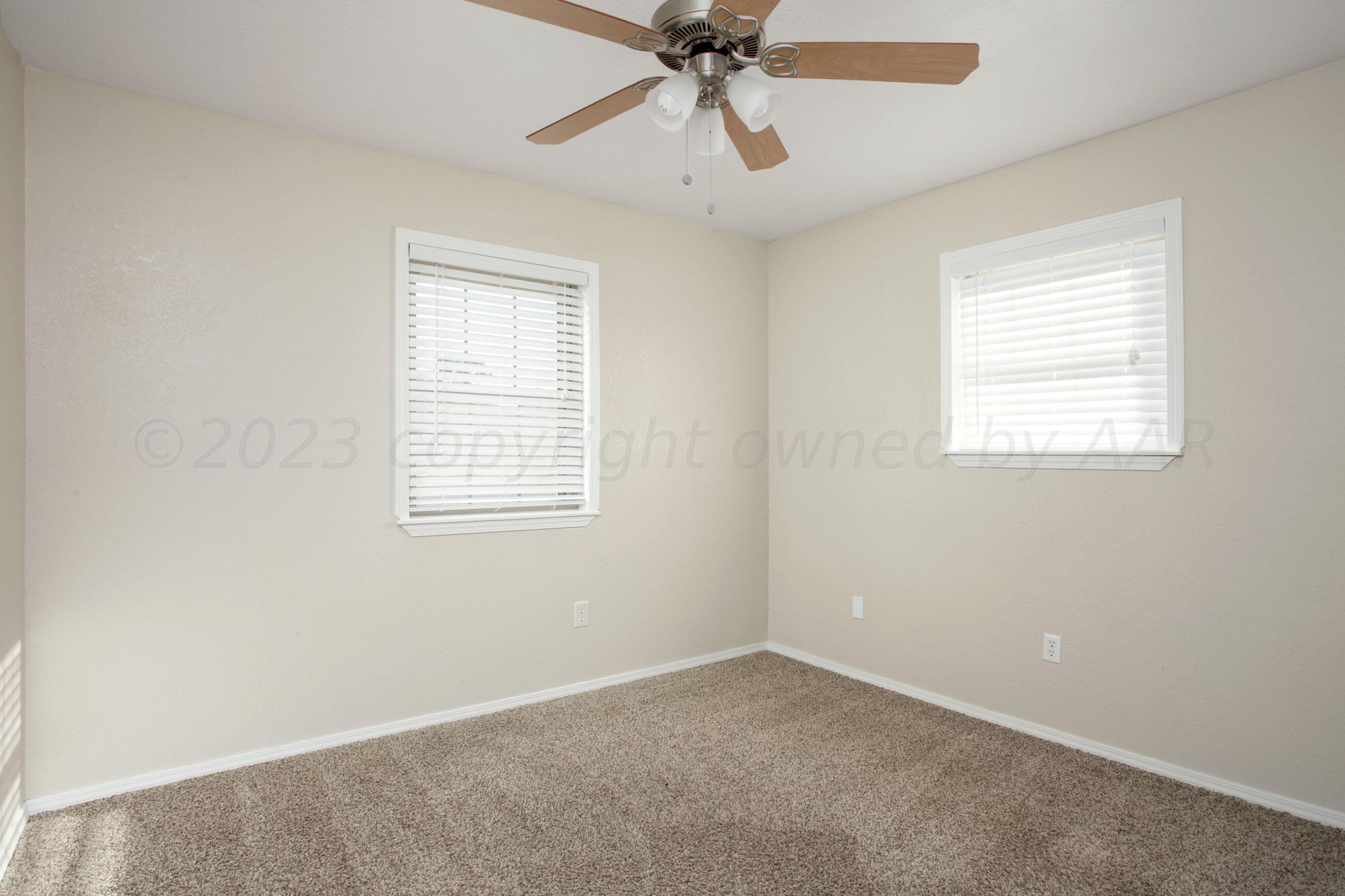 2905 Salem Drive Amarillo, TX 79110 - Photo 17 of 29 an empty room with a window and a fan