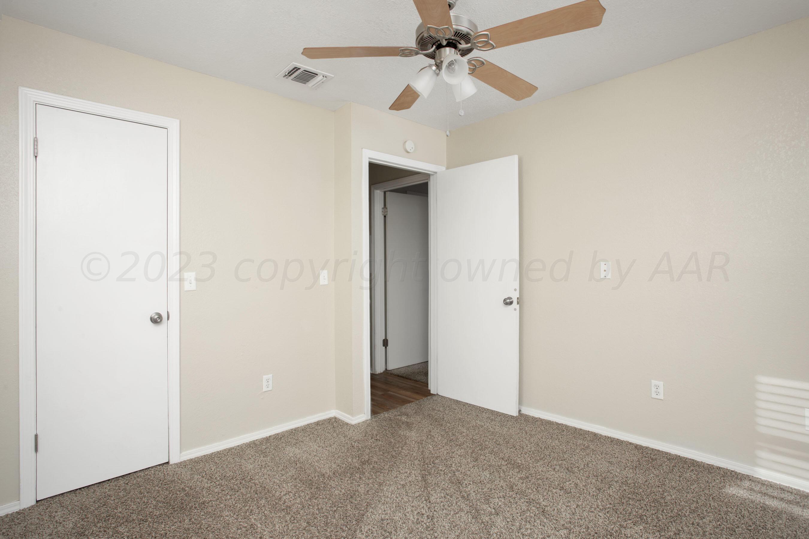 2905 Salem Drive Amarillo, TX 79110 - Photo 18 of 29 an empty room with a fan and a fan