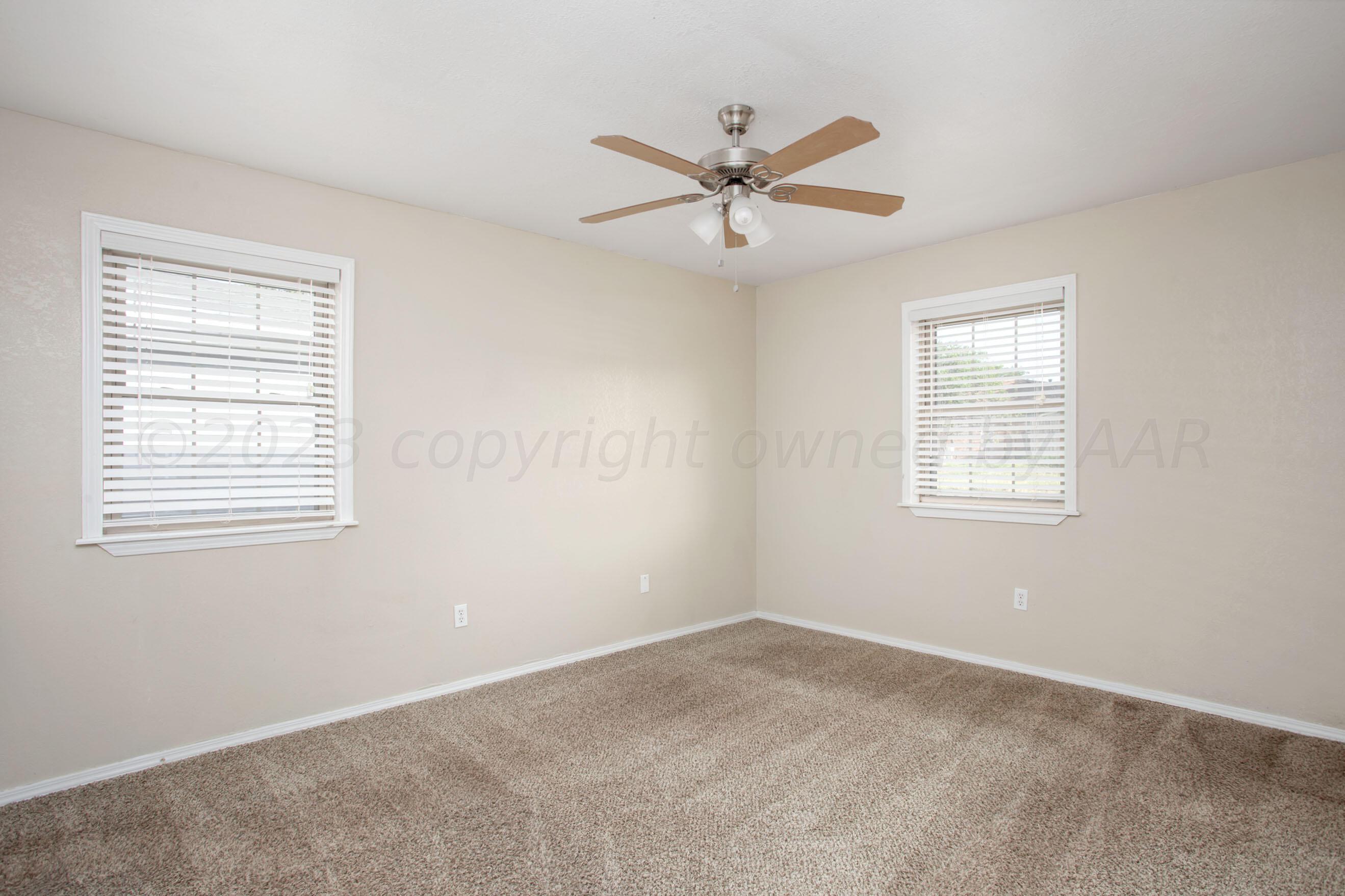 2905 Salem Drive Amarillo, TX 79110 - Photo 19 of 29 a view of a big room with wooden floor and windows
