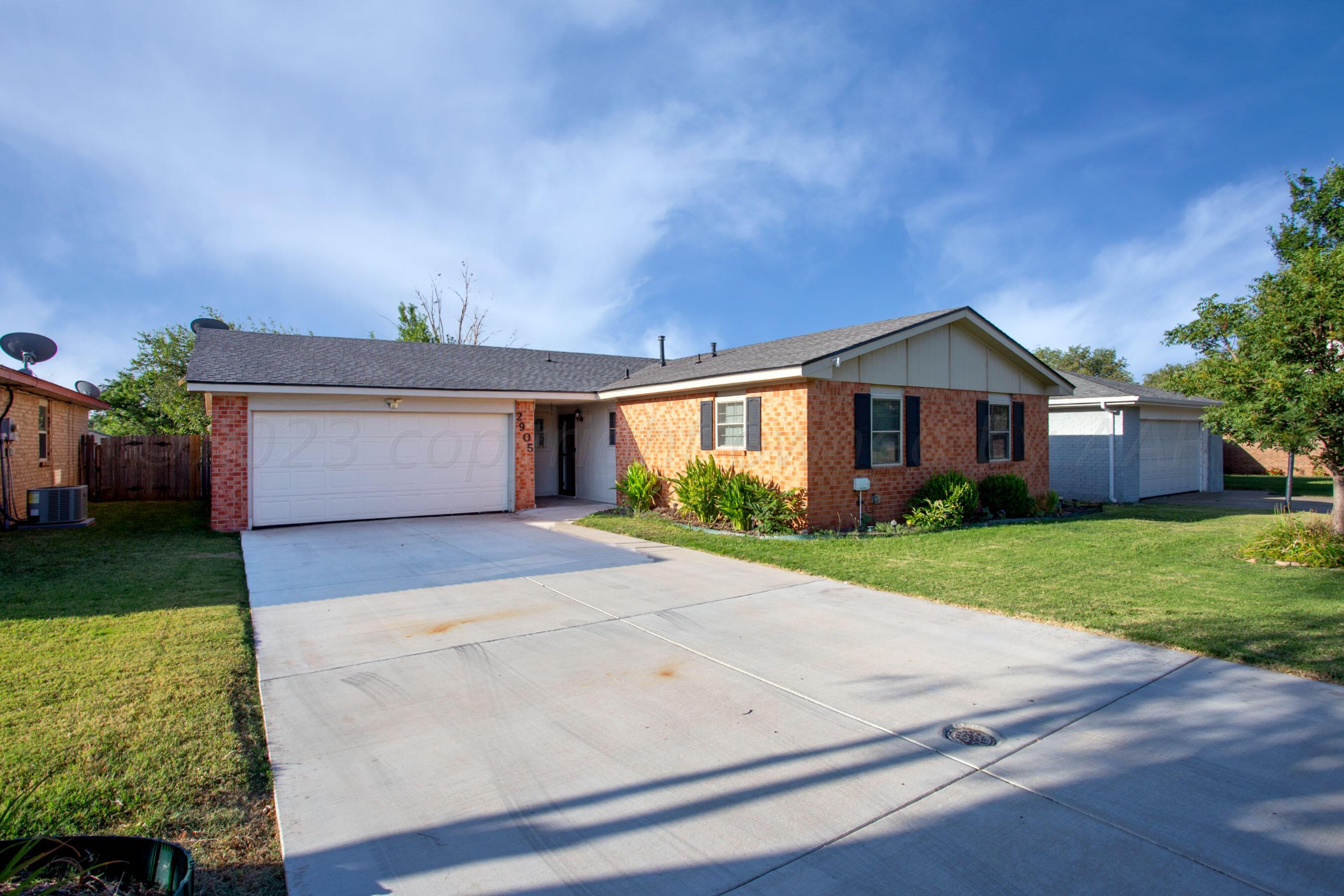 2905 Salem Drive Amarillo, TX 79110 - Photo 2 of 29 a front view of a house with a yard and garage