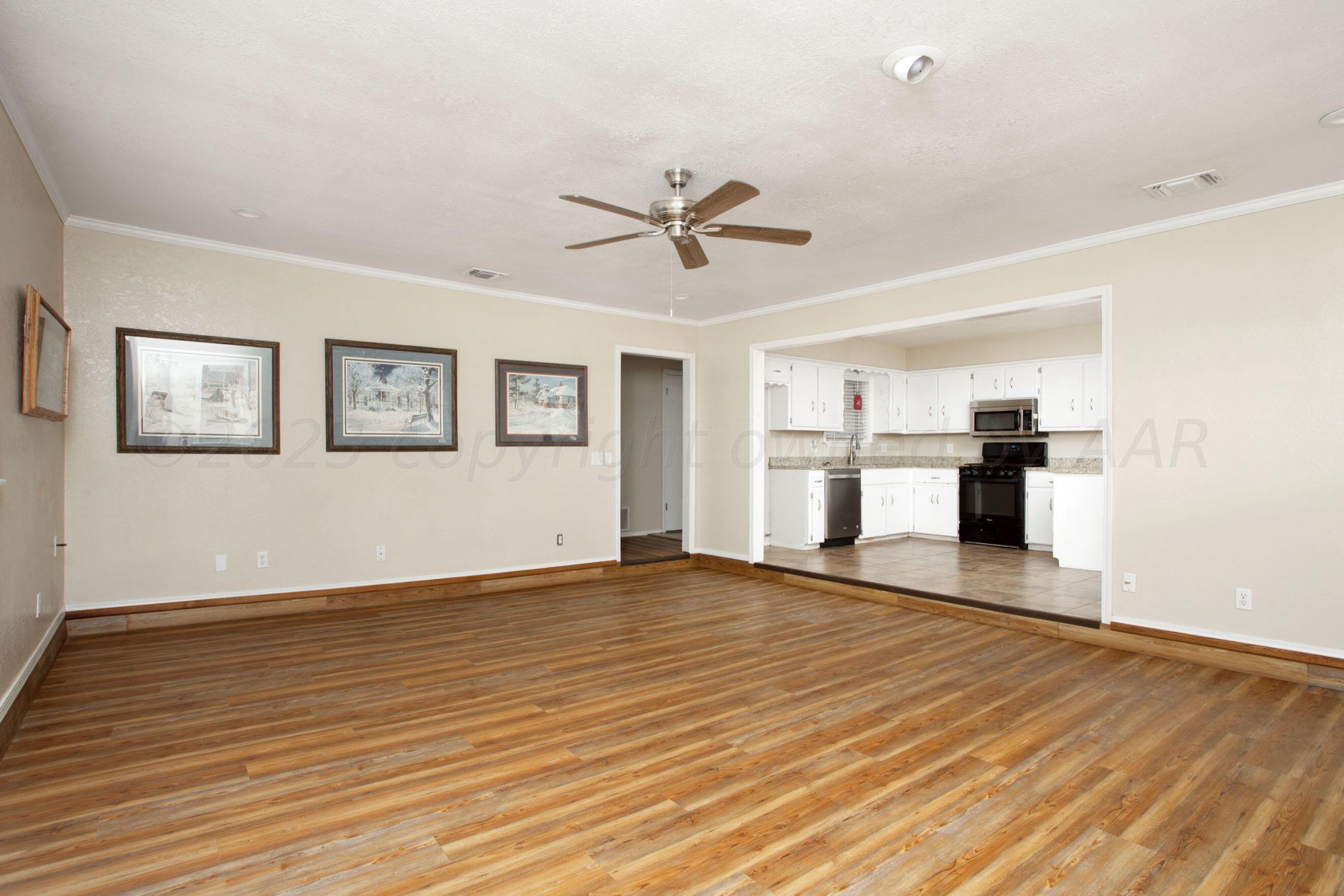 2905 Salem Drive Amarillo, TX 79110 - Photo 5 of 29 a view of a kitchen with wooden floor and a ceiling fan
