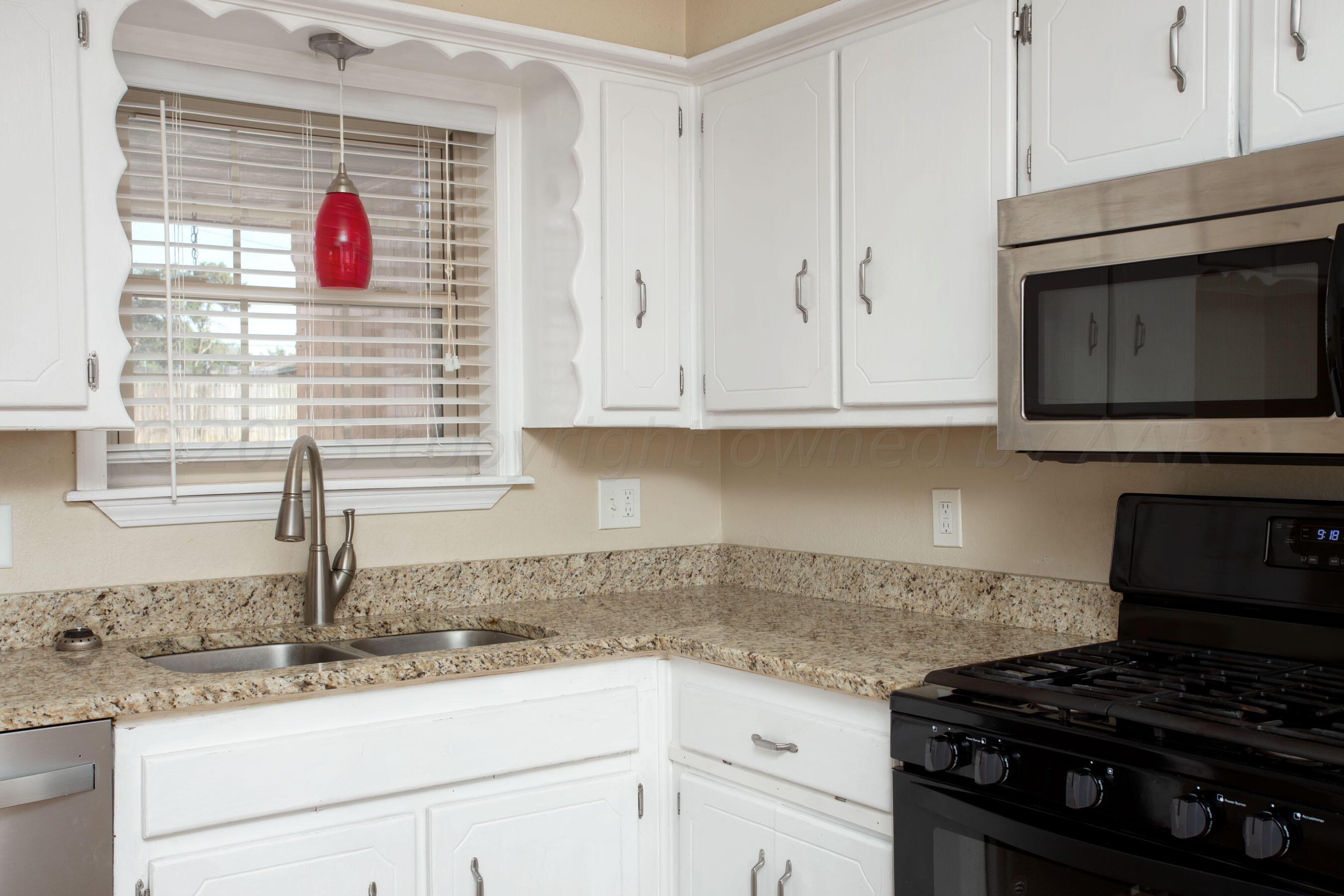2905 Salem Drive Amarillo, TX 79110 - Photo 10 of 29 a kitchen with granite countertop stainless steel appliances white cabinets and a stove
