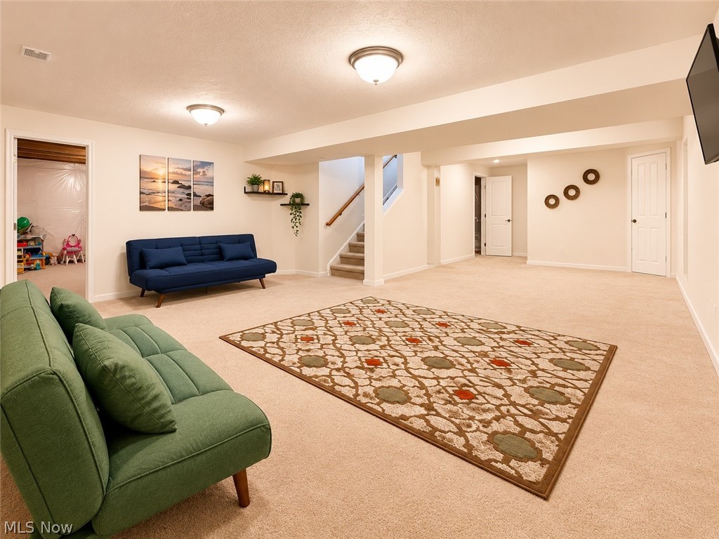 867 Starr Ridge Street Southeast Massillon, OH 44646 - Photo 23 of 29 Spacious lower level featuring plush neutral carpeting, recessed lighting, and a painted staircase with wood handrails