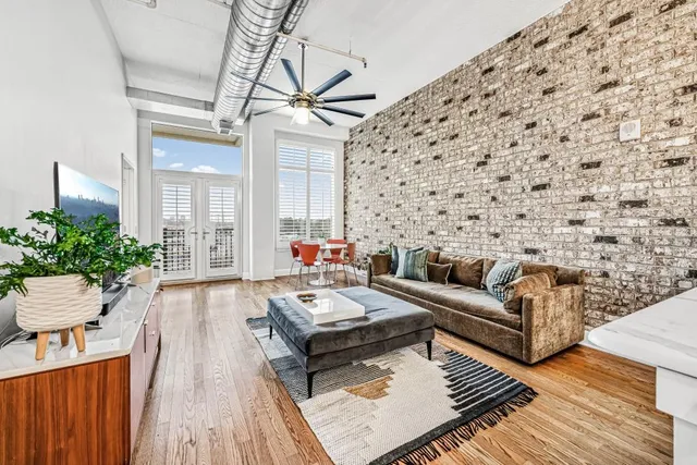 a living room with furniture and a wooden floor