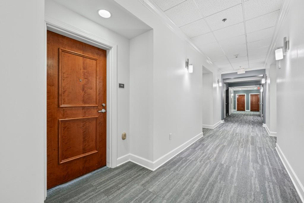 3820 Roswell Road Northeast, Unit 705 Atlanta, GA 30342 - Photo 14 of 62 a view of a hallway with wooden floor and closet
