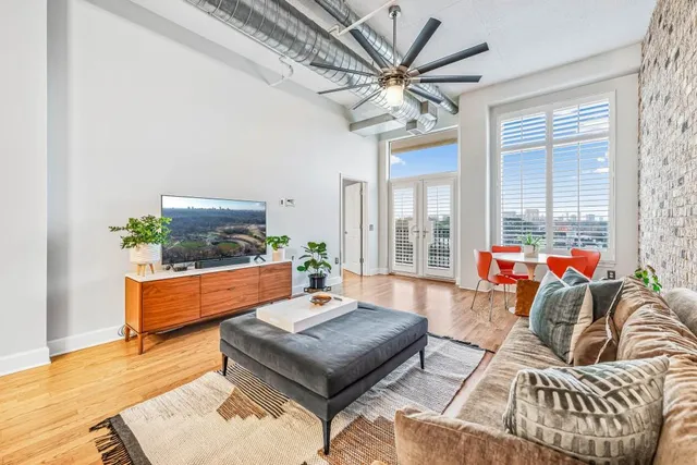 a living room with furniture a fireplace and a chandelier