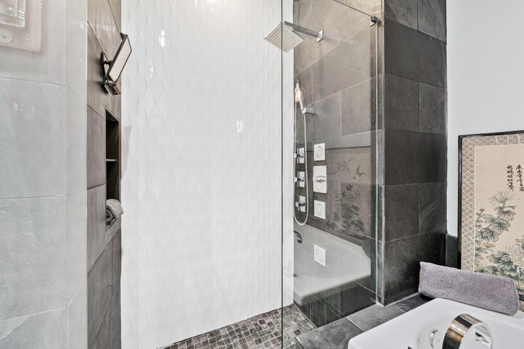 3820 Roswell Road Northeast, Unit 705 Atlanta, GA 30342 - Photo 27 of 62 a bathroom with a glass shower door