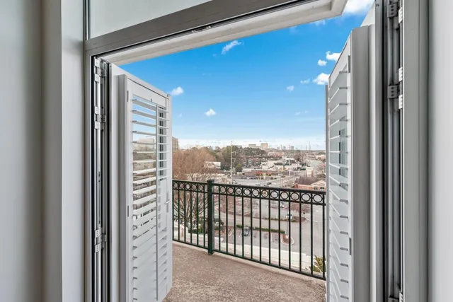 a view of a balcony with wooden floor and city view
