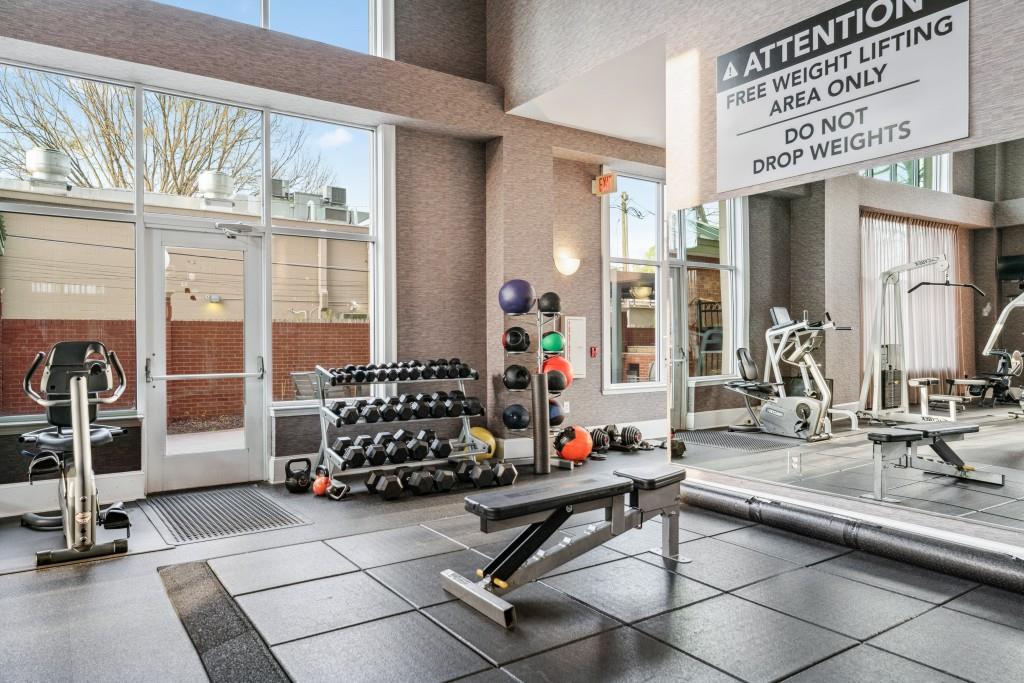 3820 Roswell Road Northeast, Unit 705 Atlanta, GA 30342 - Photo 37 of 62 a room with gym equipment and large windows