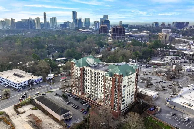 an aerial view of residential houses with outdoor space and trees