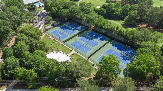 a view of a swimming pool with a yard and outdoor seating