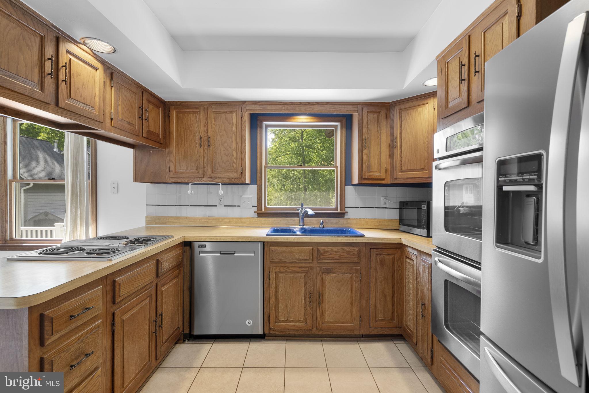 15220 Redgate Drive Silver Spring, MD 20905 - Photo 21 of 65 a kitchen with a sink stove and refrigerator
