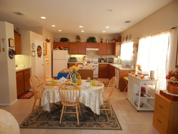 a dining room with lots of furniture and a view of living room