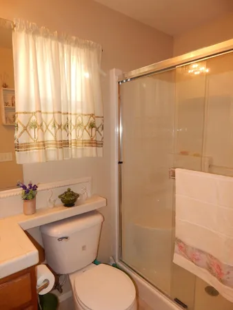 a bathroom with a toilet a sink and shower